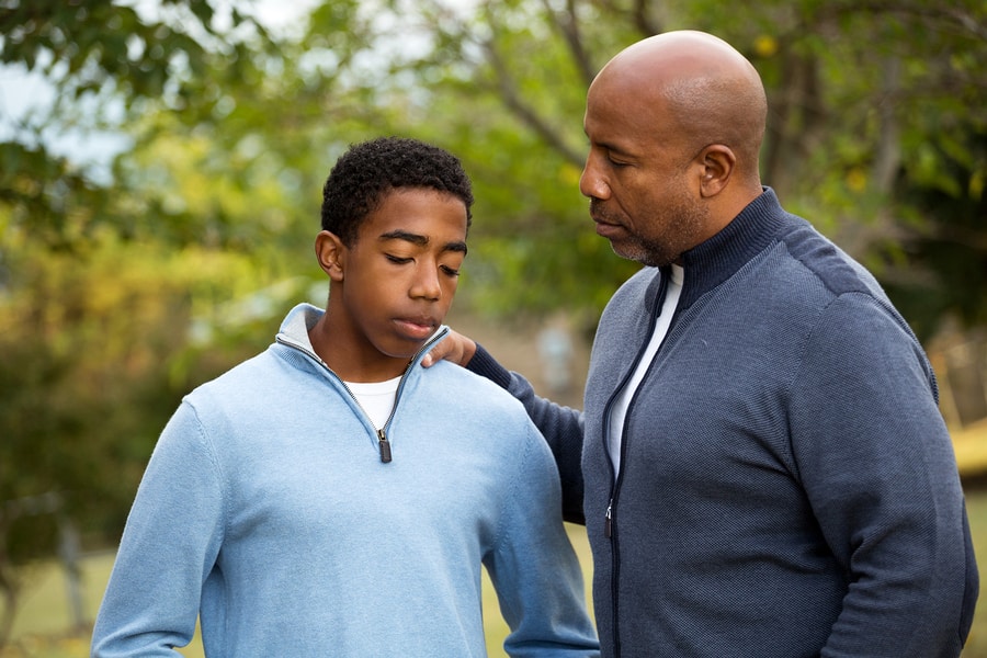 A father talking with his teenage son about interventions for alcohol abuse.