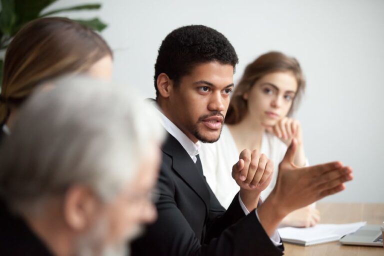 A man discusses solutions to the opioid abuse in California in a meeting.