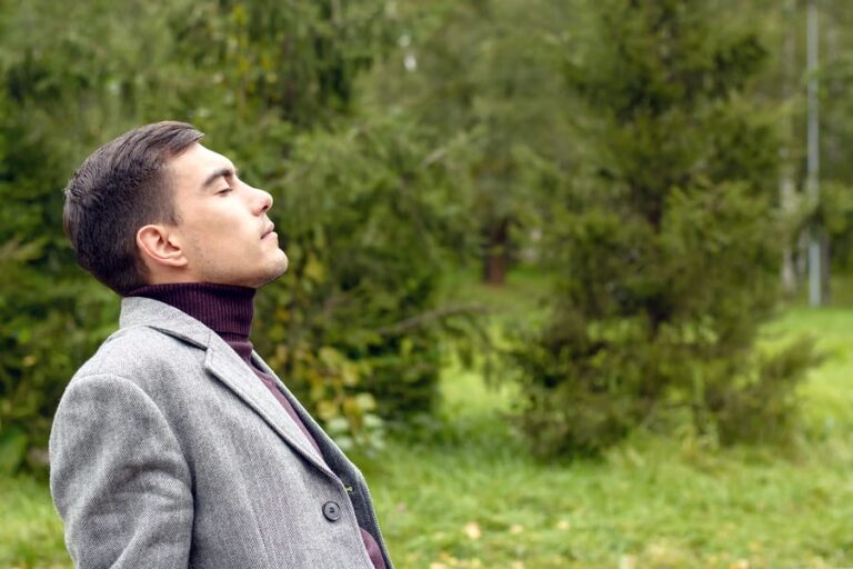 A professional man breathing in fresh air during his holistic opioid withdrawal treatment.