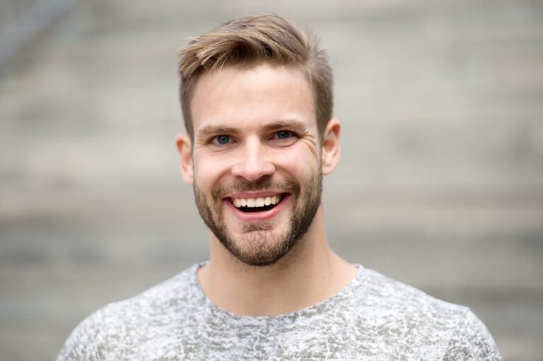 A man smiling while in rehab and benefitting from amino acid therapy for addiction.