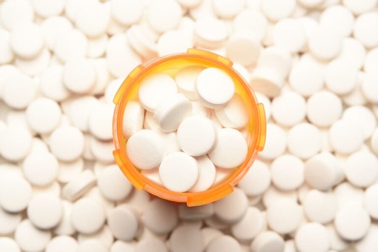A bottle filled with opioid pain pills.