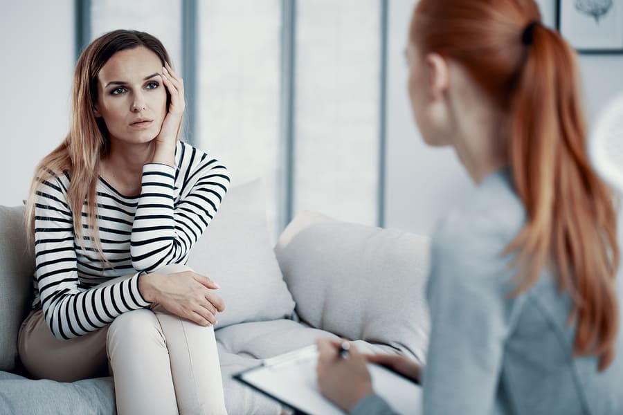 A woman in a cognitive behavioral therapy session for addiction.