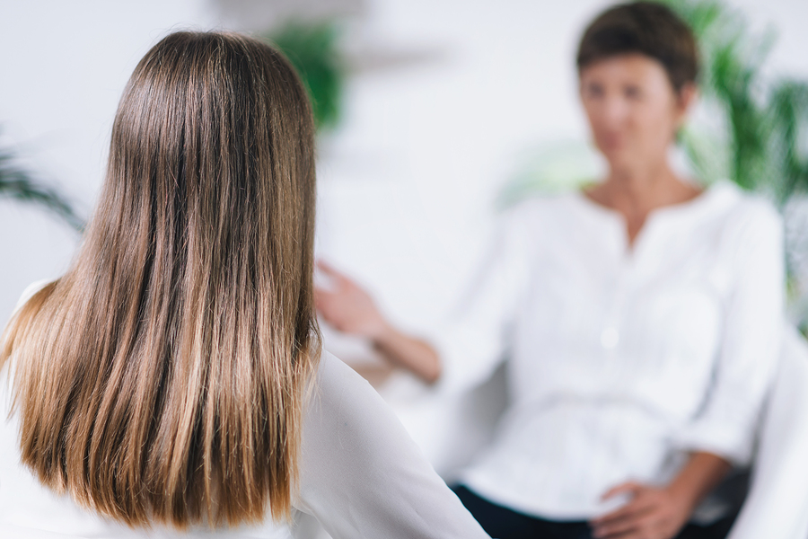 A woman and a therapist in a non-12 step dual diagnosis treatment session.