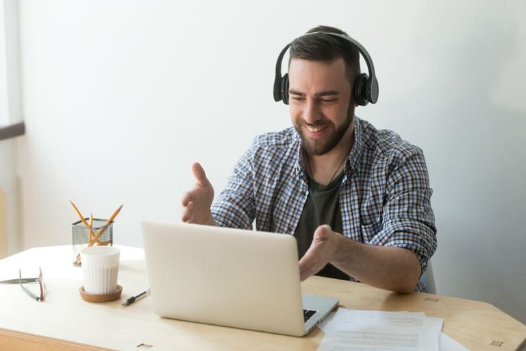 A man sits at a desk and talks during a virtual outpatient treatment session.