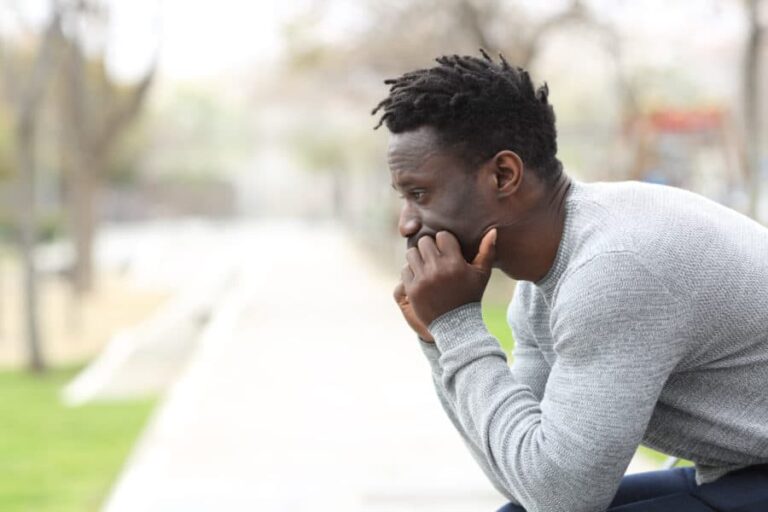 Side view portrait of a man thinking about cross addiction and cross dependence treatment.