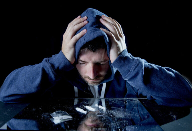 A man experiencing the dangerous side effects of cocaine use.