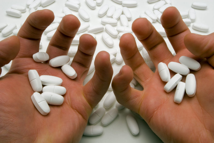 Hands of a person addicted to prescription drugs.