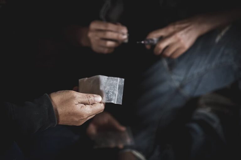 Close up of someone holding a bag of drugs