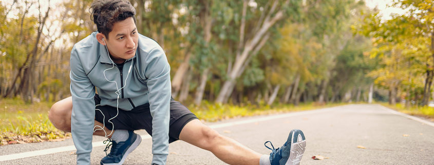 A man stretches in the park before running as part of his addiction recovery routine.
