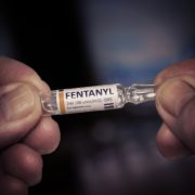 Someone holding a container of fentanyl.
