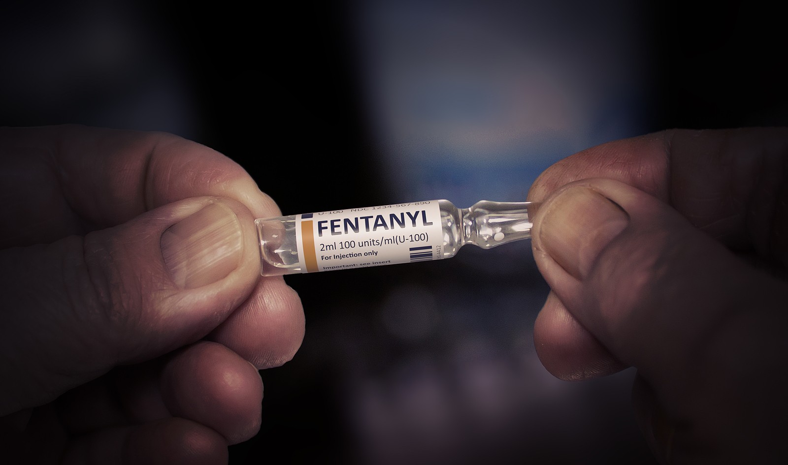 Someone holding a container of fentanyl.