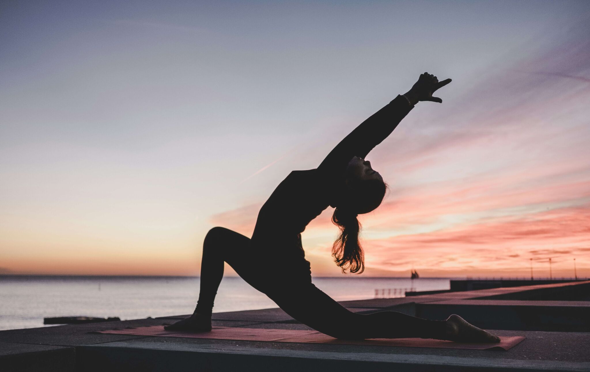 Woman doing yoga poses to practice healthy behaviors during recovery