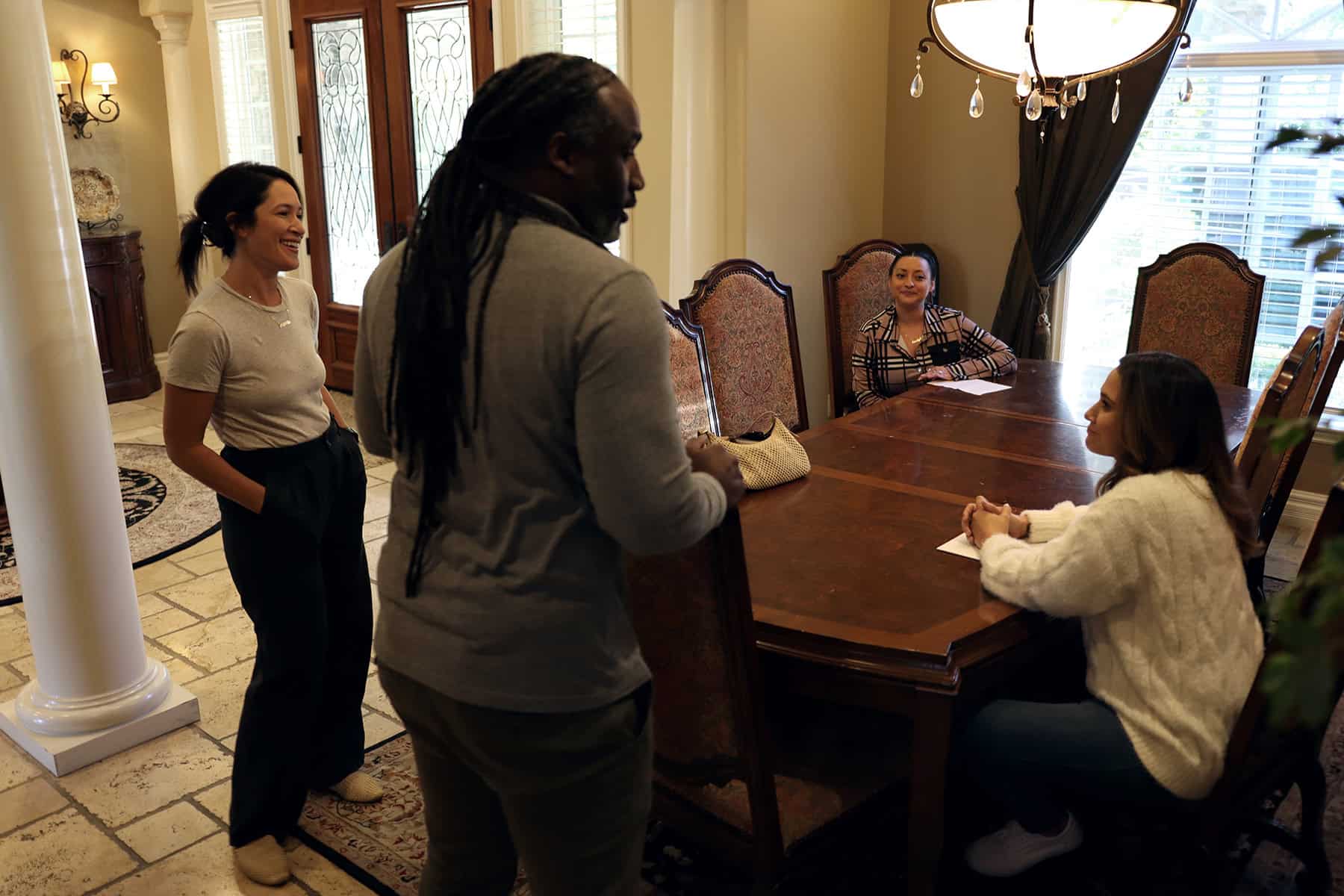 Ranch Creek Recovery staff and clients talking in the dining room of the residence