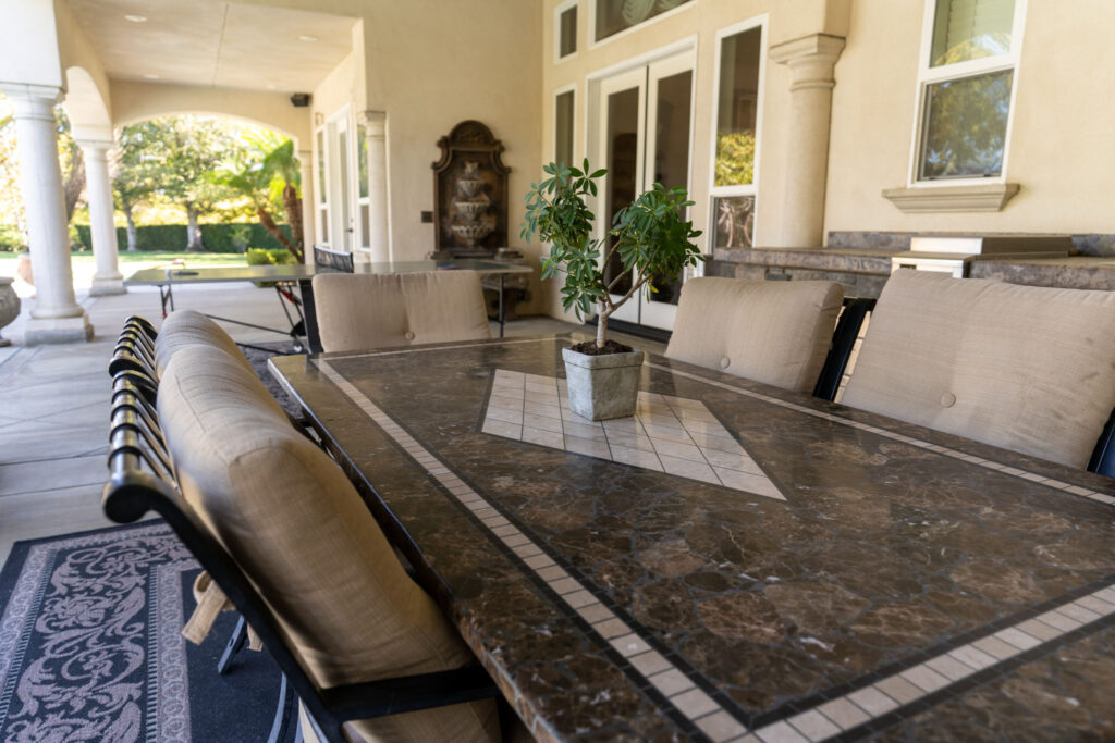 A six person stone table on a patio