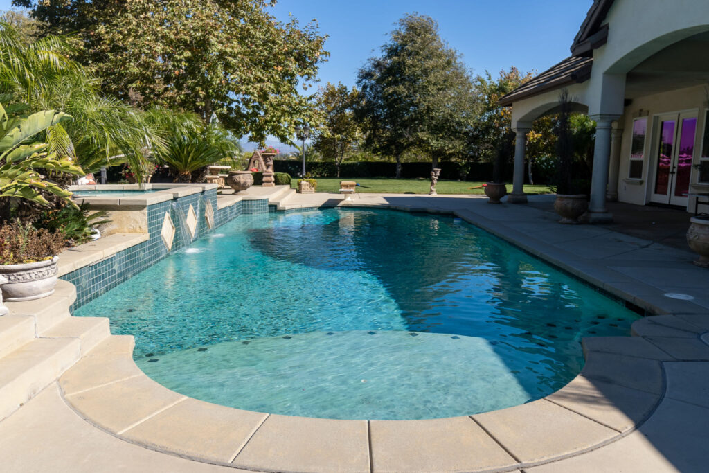 A swimming pool outside of a Bass House